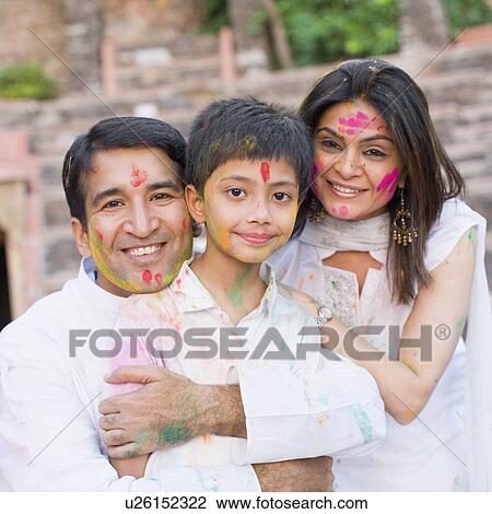 Mid adult couple with their son celebrating holi View Large Photo Image Stock Image - Mid adult couple with their son celebrating holi. Fotosearch