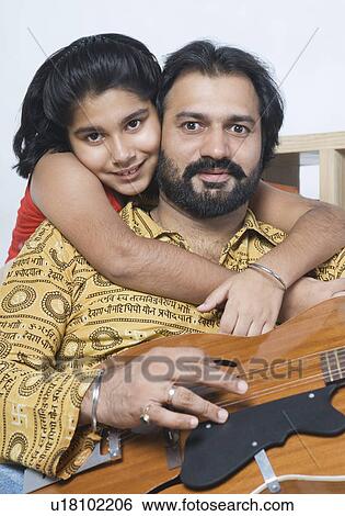 Portrait of a girl hugging her father from behind View Large Photo Image Stock Photograph - Portrait of a girl hugging her father from behind. Fotosearch