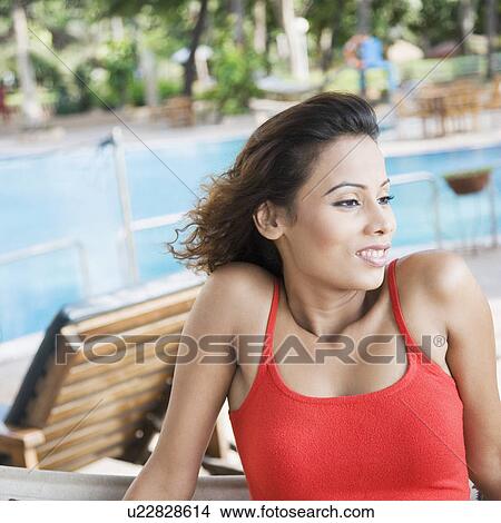 Close-up of a young woman looking away View Large Photo Image Picture - Close-up of a young woman looking away. Fotosearch