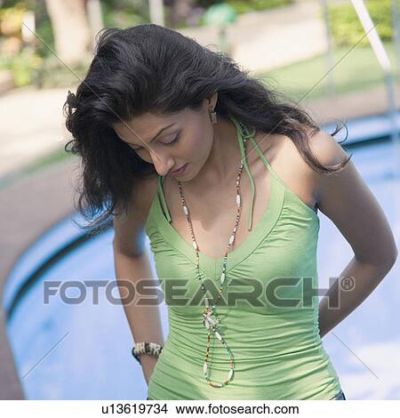Close-up of a young woman standing at the poolside View Large Photo Image Picture - Close-up of a young woman standing at the poolside. Fotosearch