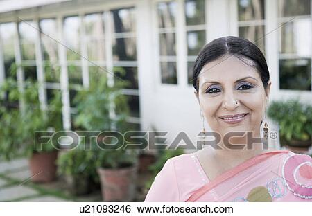 Portrait of a mature woman smiling View Large Photo Image Stock Photograph - Portrait of a mature woman smiling. Fotosearch