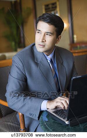 Stock Photo - Businessman working on a laptop. Fotosearch