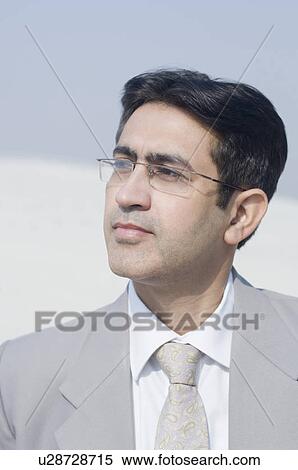 Close-up of a businessman looking away View Large Photo Image Stock Photography - Close-up of a businessman looking away. Fotosearch