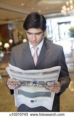 Close-up of a businessman reading a newspaper View Large Photo Image Stock Image - Close-up of a businessman reading a newspaper. Fotosearch