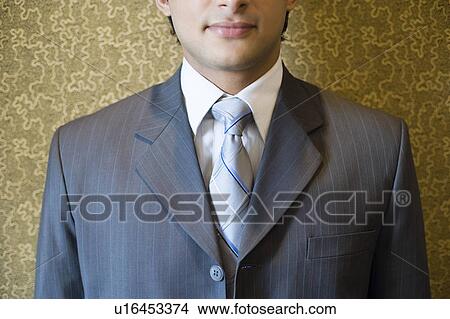 Close-up of a businessman smiling View Large Photo Image Picture - Close-up of a businessman smiling. Fotosearch
