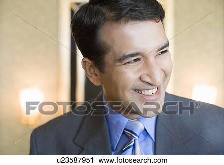 Close-up of a businessman smiling View Large Photo Image Stock Image - Close-up of a businessman smiling. Fotosearch