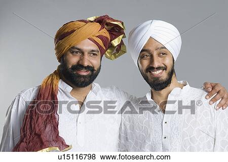 Close-up of a mid adult man standing with his arm around to a young man View Large Photo Image Stock Photo - Close-up of a mid adult man standing with his arm around to a young man. Fotosearch