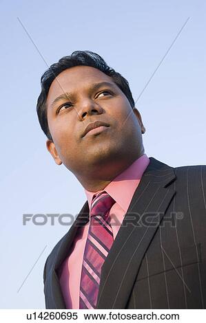 Close-up of a mid adult man thinking View Large Photo Image Stock Photography - Close-up of a mid adult man thinking. Fotosearch