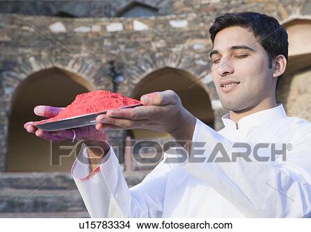 Close-up of a young man holding a plate of powder paint View Large Photo Image Picture - Close-up of a young man holding a plate of powder paint. Fotosearch