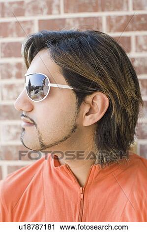 Close-up of a young man wearing sunglasses View Large Photo Image Stock Image - Close-up of a young man wearing sunglasses. Fotosearch