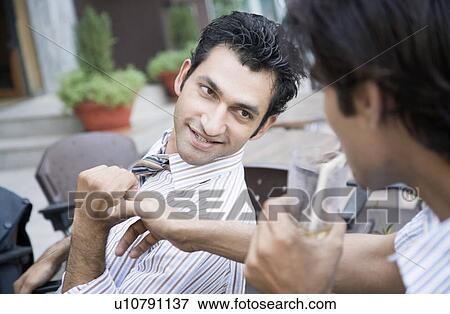 Stock Photo - Close-up of two young men smiling. Fotosearch