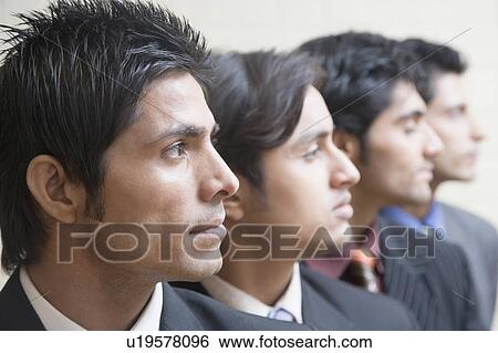 Four businessmen in a row View Large Photo Image Stock Photograph - Four businessmen in a row. Fotosearch