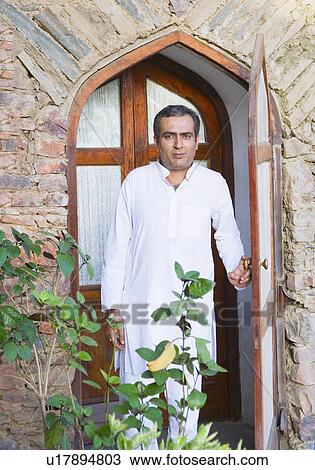 Portrait of a mid adult man standing at the door View Large Photo Image Stock Image - Portrait of a mid adult man standing at the door. Fotosearch