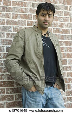 Portrait of a mid adult man standing with his hands in his pockets View Large Photo Image Stock Photo - Portrait of a mid adult man standing with his hands in his pockets. Fotosearch