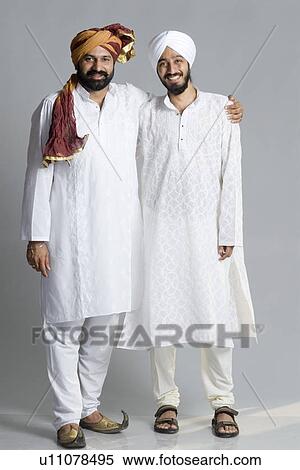 Stock Photography - Portrait of a mid adult man standing with his arm around a young man. Fotosearch