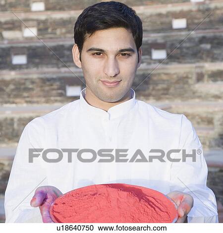Portrait of a young man holding a plate of powder paint View Large Photo Image Stock Image - Portrait of a young man holding a plate of powder paint. Fotosearch