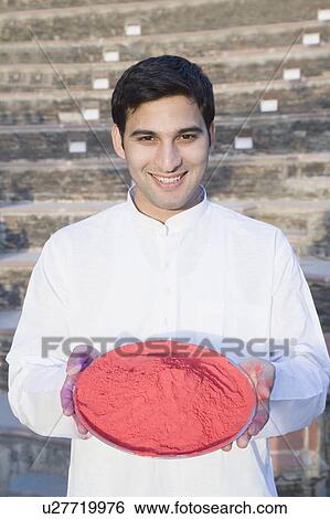 Portrait of a young man holding a plate of powder paint and smiling View Large Photo Image Stock Photograph - Portrait of a young man holding a plate of powder paint and smiling. Fotosearch