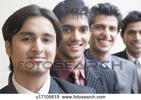Stock Photo - Portrait of four businessmen smiling in a row. Fotosearch
