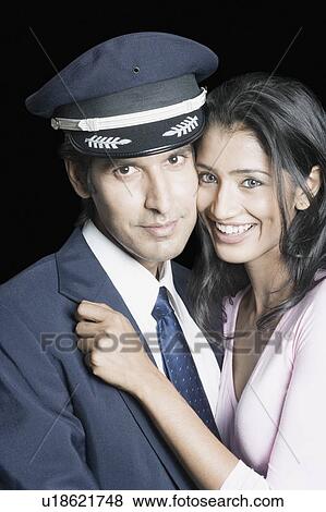 Portrait of a young couple embracing each other and smiling View Large Photo Image Stock Photo - Portrait of a young couple embracing each other and smiling. Fotosearch