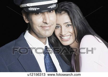 Stock Image - Portrait of a young couple smiling. Fotosearch