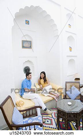 Young couple sitting on the bed View Large Photo Image Stock Image - Young couple sitting on the bed. Fotosearch