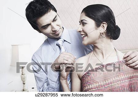 Close-up of a young couple looking at each other View Large Photo Image Stock Photography - Close-up of a young couple looking at each other. Fotosearch