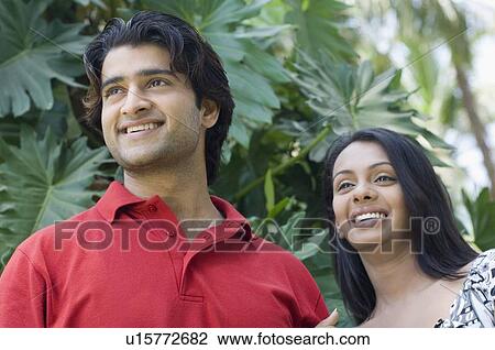 Close-up of a young couple smiling View Large Photo Image Stock Image - Close-up of a young couple smiling. Fotosearch