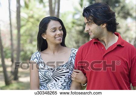 Close-up of a young couple with arm in arm and smiling View Large Photo Image Stock Photography - Close-up of a young couple with arm in arm and smiling. Fotosearch