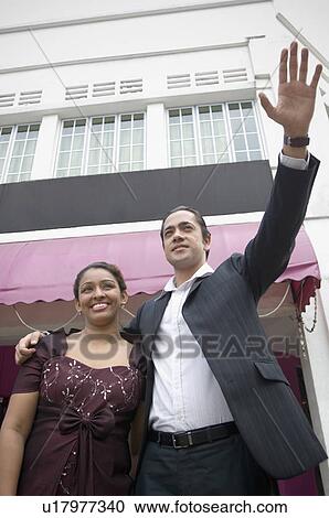 Low angle view of a mid adult man with a young woman smiling View Large Photo Image Stock Image - Low angle view of a mid adult man with a young woman smiling. Fotosearch