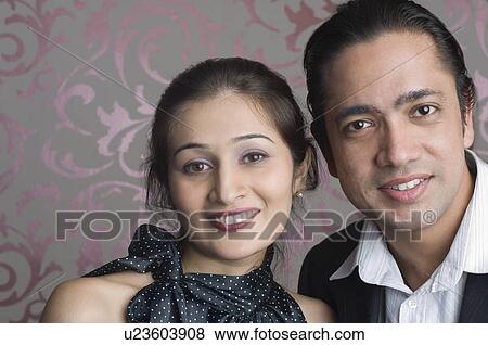 Stock Photo - Portrait of a mid adult man smiling with a young woman. Fotosearch