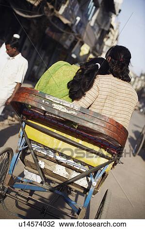 Rear view of a young couple sitting in a rickshaw View Large Photo Image Stock Image - Rear view of a young couple sitting in a rickshaw. Fotosearch