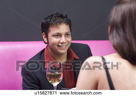 Young couple sitting in a restaurant View Large Photo Image Stock Image - Young couple sitting in a restaurant. Fotosearch
