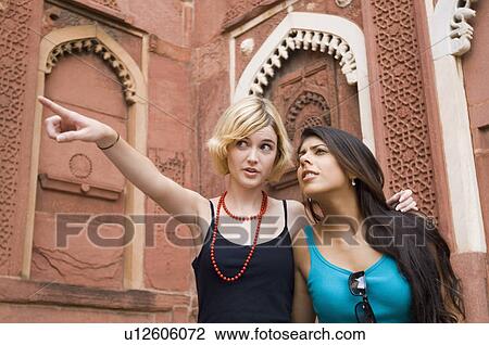 Close-up of a young woman pointing away with her friend, Taj Mahal, Agra, Uttar Pradesh, India View Large Photo Image Stock Image - Close-up of a young woman pointing away with her friend, Taj Mahal, Agra, Uttar Pradesh, India. Fotosearch