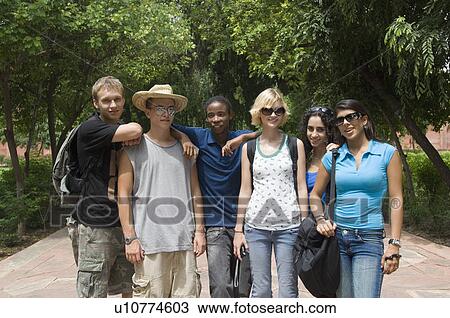 Stock Image - Portrait of three young couples standing together, Taj Mahal, Agra, Uttar Pradesh, India. Fotosearch