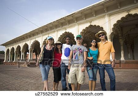 Stock Photo - Portrait of three young couples standing in front of a mausoleum, Taj Mahal, Agra, Uttar Pradesh, India. Fotosearch