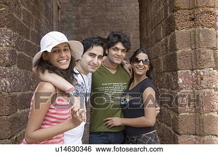 Portrait of two young couples standing together and smiling, Goa, India View Large Photo Image Stock Photograph - Portrait of two young couples standing together and smiling, Goa, India. Fotosearch