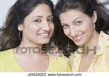 Portrait of two young women smiling View Large Photo Image Stock Image - Portrait of two young women smiling. Fotosearch