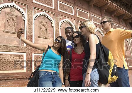 Young woman standing with her friends and taking a picture of themselves, Taj Mahal, Agra, Uttar Pradesh, India View Large Photo Image Stock Photo - Young woman standing with her friends and taking a picture of themselves, Taj Mahal, Agra, Uttar Pradesh, India. Fotosearch