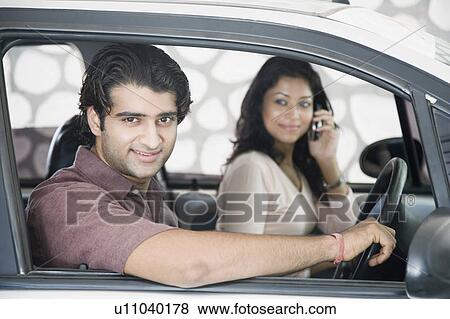 Close-up of a young couple sitting in a car View Large Photo Image Stock Photo - Close-up of a young couple sitting in a car. Fotosearch
