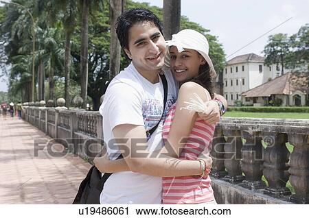 Portrait of a young couple embracing each other and smiling, Goa, India View Large Photo Image Stock Image - Portrait of a young couple embracing each other and smiling, Goa, India. Fotosearch