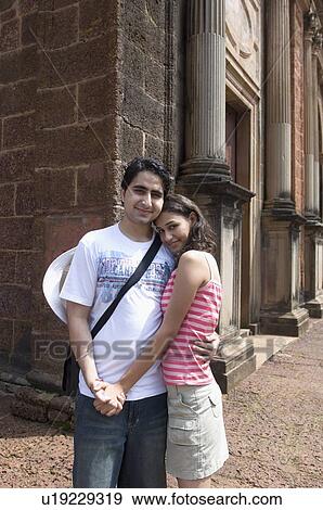 Portrait of a young couple embracing each other and smiling, Goa, India View Large Photo Image Stock Photo - Portrait of a young couple embracing each other and smiling, Goa, India. Fotosearch
