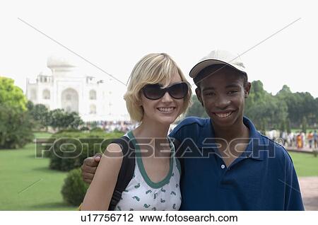Portrait of a young couple smiling in front of mausoleum, Taj Mahal, Agra, Uttar Pradesh, India View Large Photo Image Stock Image - Portrait of a young couple smiling in front of mausoleum, Taj Mahal, Agra, Uttar Pradesh, India. Fotosearch