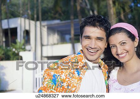 Portrait of a young couple smiling View Large Photo Image Stock Photo - Portrait of a young couple smiling. Fotosearch