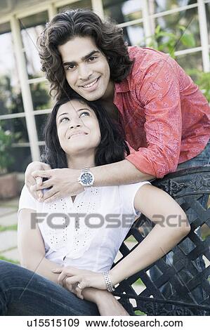 Portrait of a young man embracing a young woman from behind View Large Photo Image Stock Photo - Portrait of a young man embracing a young woman from behind. Fotosearch