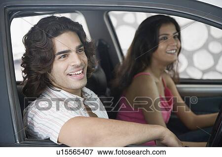 Side profile of a young couple sitting inside a car and smiling View Large Photo Image Stock Photo - Side profile of a young couple sitting inside a car and smiling. Fotosearch