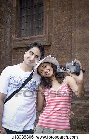 Young couple making a film of themselves with a home video camera, Goa, India View Large Photo Image Stock Photograph - Young couple making a film of themselves with a home video camera, Goa, India. Fotosearch