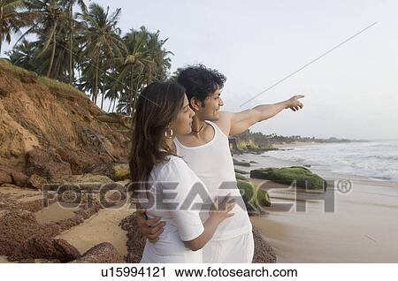 Young couple standing on the beach and looking at the view, Goa, India View Large Photo Image Stock Image - Young couple standing on the beach and looking at the view, Goa, India. Fotosearch