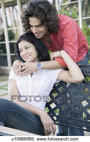 Young man embracing a young woman from behind View Large Photo Image Stock Photography - Young man embracing a young woman from behind. Fotosearch