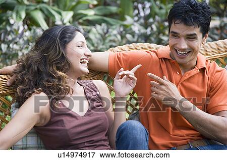 Close-up of a young couple laughing View Large Photo Image Stock Photo - Close-up of a young couple laughing. Fotosearch