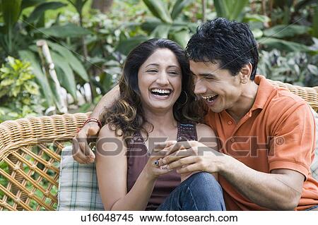 Close-up of a young couple laughing View Large Photo Image Stock Photography - Close-up of a young couple laughing. Fotosearch